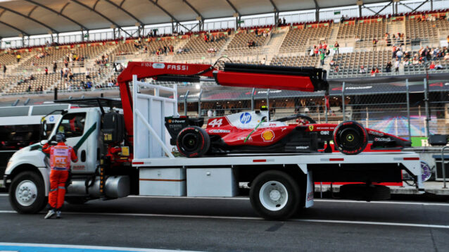 Lewis Hamilton's stricken Ferrari is returned to the pits on a truck